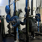 man squatting at Belding Performance